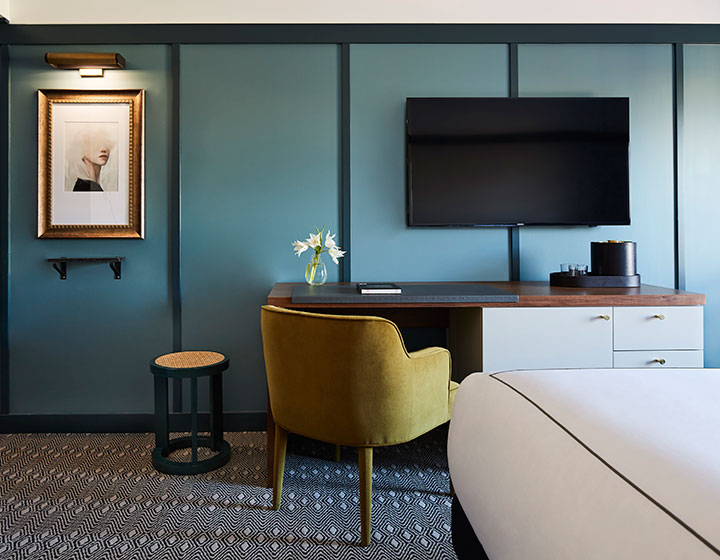 View of desk with chair and TV at Kimpton Saint George Hotel